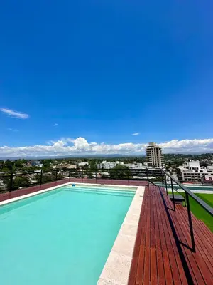 a swimming pool on the roof of a building at Depa a Estrenar en el Centro, Pile, Aire Ac in Villa Carlos Paz