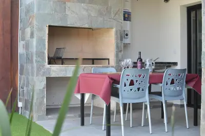 a dining room with a table and chairs and a fireplace at Departamento en Villa Carlos paz in Villa Carlos Paz