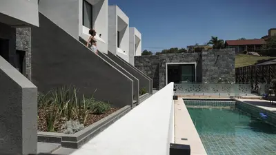 a woman walking down the stairs of a house at Departamento en Villa Carlos paz in Villa Carlos Paz