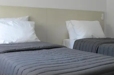 two beds sitting next to each other in a room at Departamento en Villa Carlos paz in Villa Carlos Paz