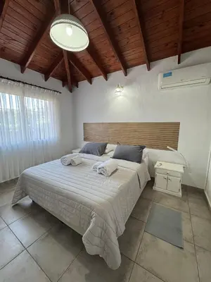 a bedroom with a large bed with towels on it at Merlinda in Merlo