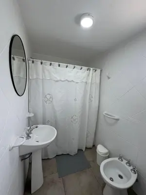 a bathroom with a sink and a toilet and a mirror at Merlinda in Merlo
