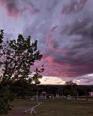 a cloudy sky over a field with a soccer field at Cabañas Don Luis in San Lorenzo