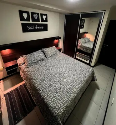 a bedroom with a bed and a large mirror at Miralejos VII - Edificio Premium - Departamento 1 Dormitorio in Villa Carlos Paz