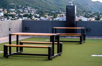 two benches sitting on top of a building at Miralejos VII - Edificio Premium - Departamento 1 Dormitorio in Villa Carlos Paz