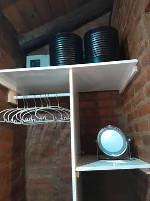a white shelf with black plates on it at Cabañas Franca Austral in Santa Rosa de Calamuchita
