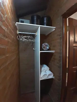 a cupboard with plates and dishes in a room at Cabañas Franca Austral in Santa Rosa de Calamuchita
