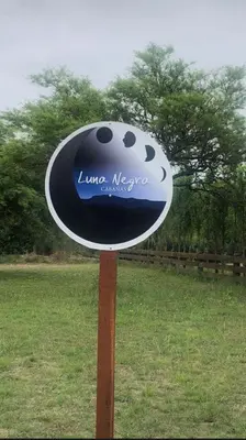 a sign for a lake michigan in a field at LunaNegra Casas de descanso in Villa General Belgrano