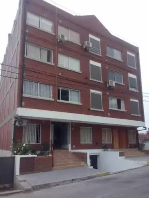 a large red brick building on the corner of a street at Carlos paz tower in Villa Carlos Paz