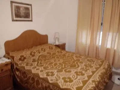a bedroom with a bed with a comforter on it at Carlos paz tower in Villa Carlos Paz