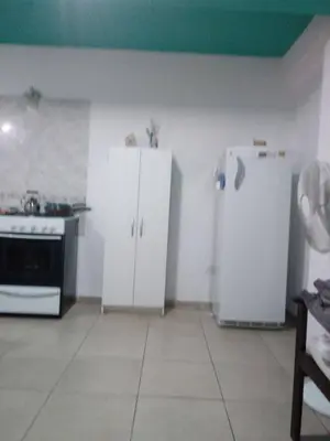 a kitchen with white cabinets and a white refrigerator at Carlos paz tower in Villa Carlos Paz