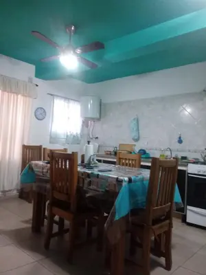 a kitchen with a table with chairs and a ceiling fan at Carlos paz tower in Villa Carlos Paz