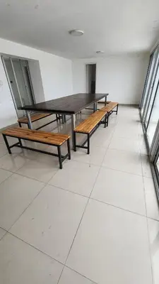 a table and benches in a room with windows at Viamonte deluxe Barrio General Paz 2 dormitorios in Cordoba