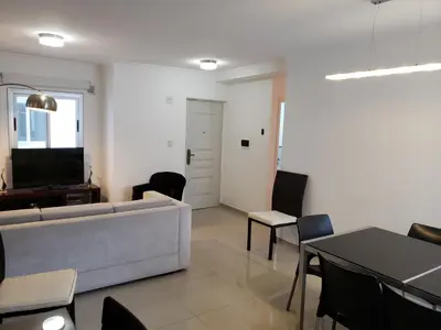 a living room with a couch and a table and chairs at Viamonte deluxe Barrio General Paz 2 dormitorios in Cordoba