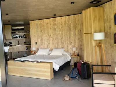 a bedroom with a bed with a wooden wall at Escapada romántica en El Leon in San Javier