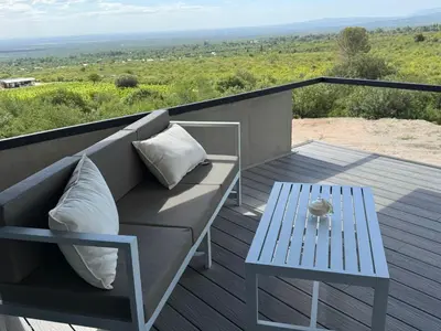a couch and a table on a balcony at Escapada romántica en El Leon in San Javier
