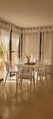 a dining room with a white table and chairs at FlussHaus3 in Villa General Belgrano