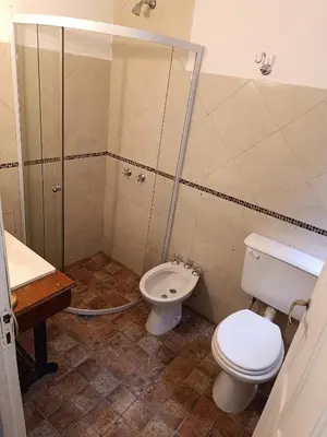a bathroom with a toilet and a shower at Sonidos del Rio Aparts in Santa Rosa de Calamuchita