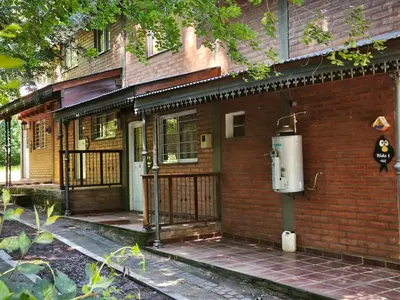 a brick house with an electricity meter on the side of it at Sonidos del Rio Aparts in Santa Rosa de Calamuchita