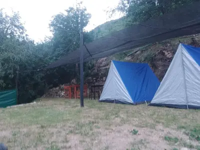 two blue and white tents in a field at Campamento Monarcas in Villa Carlos Paz