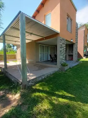 a house with awning on a patio at Complejo El Aguaribay in Potrero de Garay