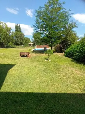 a park with a bench in the grass at Complejo El Aguaribay in Potrero de Garay