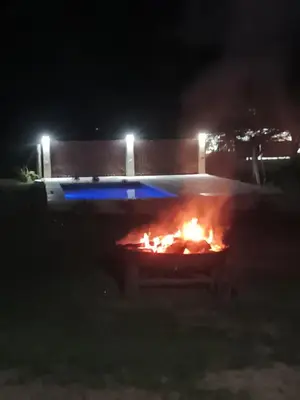 a large fire in a yard at night at Complejo El Aguaribay in Potrero de Garay