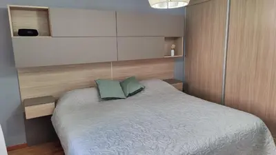 a bedroom with a bed with two green pillows at Departamento de lujo en Nueva Cordoba in Cordoba