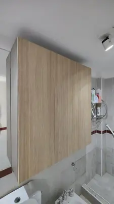 a bathroom with a sink and a wooden cabinet at Departamento de lujo en Nueva Cordoba in Cordoba