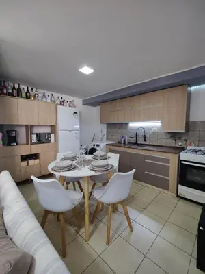 a kitchen with a table and white chairs in a room at Departamento de lujo en Nueva Cordoba in Cordoba