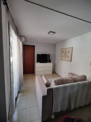 a living room with a couch and a television at Departamento de lujo en Nueva Cordoba in Cordoba