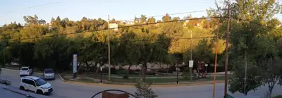 a street with cars parked in a parking lot at Complejo Luluara in Villa Carlos Paz