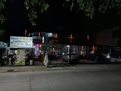 a sign in front of a building at night at Complejo Luluara in Villa Carlos Paz