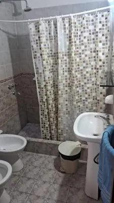 a bathroom with a sink and a toilet and a shower at Complejo Luluara in Villa Carlos Paz