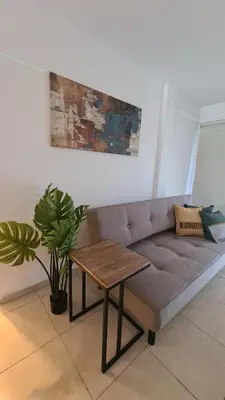 a living room with a couch and a table at MAGNUS, 2 baños, 2 hab, TODO NUEVO! en el corazón de Carlos Paz in Villa Carlos Paz
