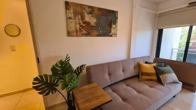 a living room with a couch and a table at MAGNUS, 2 baños, 2 hab, TODO NUEVO! en el corazón de Carlos Paz in Villa Carlos Paz