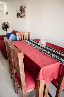 a table with a red table cloth on top of it at Depto 1 dormitorio de categoria en Barrio General Paz in Cordoba
