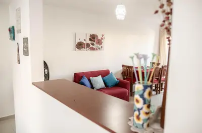a living room with a table and a red couch at Depto 1 dormitorio de categoria en Barrio General Paz in Cordoba