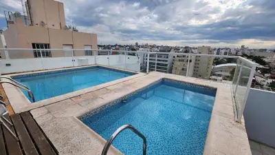 a swimming pool on the roof of a building at Depto 1 dormitorio de categoria en Barrio General Paz in Cordoba