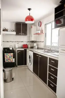 a kitchen with a washer and dryer in it at Depto 1 dormitorio de categoria en Barrio General Paz in Cordoba