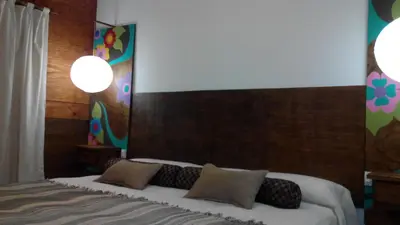 a bedroom with a bed with two pillows on it at Clima Serrano in Merlo