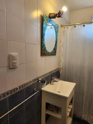 a bathroom with a sink and a mirror at Clima Serrano in Merlo