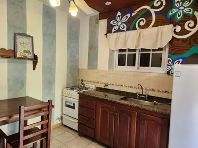 a kitchen with a sink and a stove and a window at Clima Serrano in Merlo