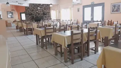 a dining room filled with tables and chairs at Hotel Nuevo Fatica in Villa Carlos Paz