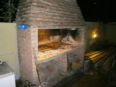a brick oven with a grill in it at Hotel Nuevo Fatica in Villa Carlos Paz