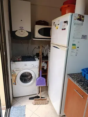 a kitchen with a washing machine and a refrigerator at Departamento en general paz in Cordoba