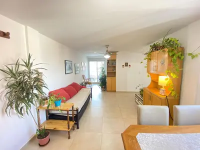 a living room with a couch and a table at Espacio C Jardín con estacionamiento in Cordoba