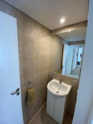 a bathroom with a sink and a mirror at Espacio C Jardín con estacionamiento in Cordoba
