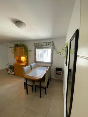 a dining room table and chairs in a room at Espacio C Jardín con estacionamiento in Cordoba