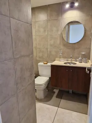 a bathroom with a toilet and a sink and a mirror at Espacio C Av PUEYRREDÓN con estacionamiento in Cordoba